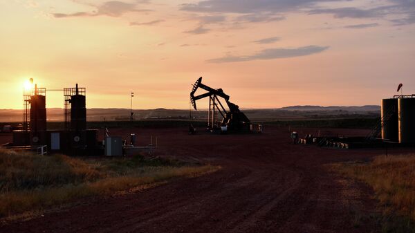 An oil well works at sunrise Aug. 25, 2021, in Watford City, N.D., part of McKenzie County. - Sputnik International
