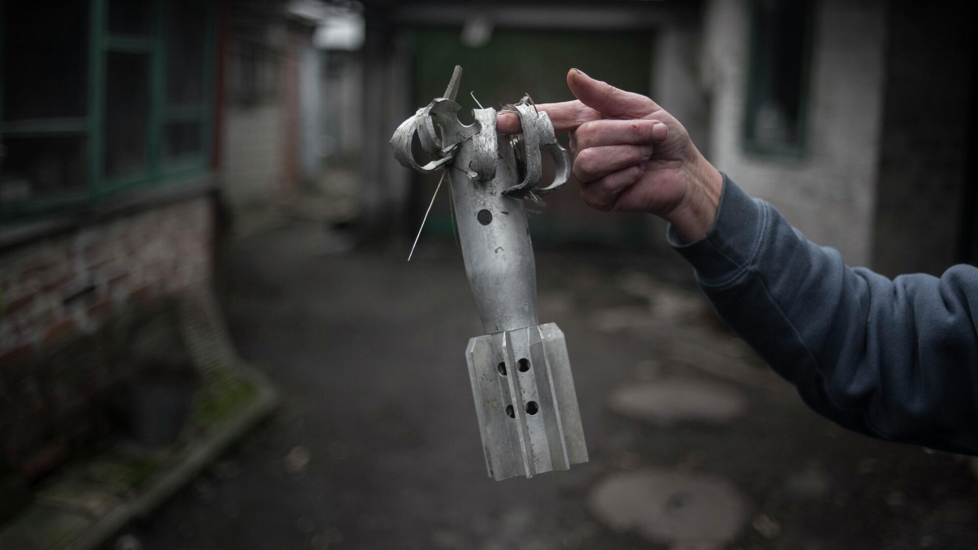 A woman shows a fragment of a mortar projectile in the village of Zaytsevo, Donetsk People’s Republic. Last month, the DPR’s Ministry of Emergency Situations declared that demining Donbass would take decades. - Sputnik International, 1920, 07.07.2022