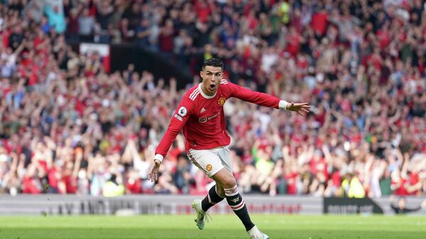 Manchester United's Cristiano Ronaldo celebrates after scoring his third goal during the English Premier League soccer match between Manchester United and Norwich City at Old Trafford stadium in Manchester, England, Saturday, April 16, 2022. - Sputnik International