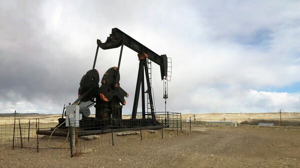 This Feb. 26, 2021, file photo shows an oil well east of Casper, Wyo. The Biden administration is raising royalty rates that companies must pay for oil and natural gas extracted from federal lands as it moves forward under court order with sales of public fossil fuel reserves in nine states. - Sputnik International