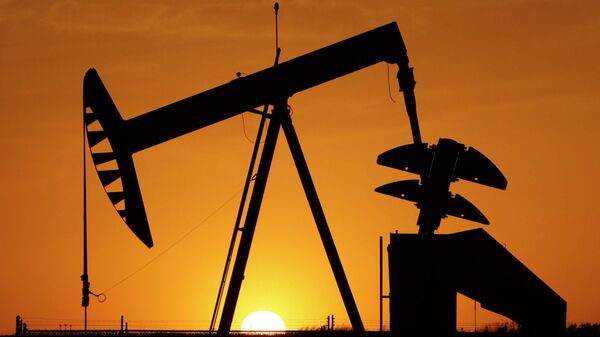 A pump jack is silhouetted against the setting sun in Oklahoma City on March 22, 2012. - Sputnik International