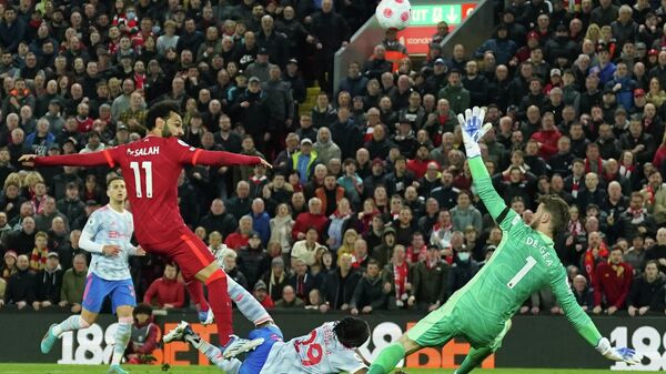 Liverpool's Mohamed Salah, left, scores his side's fourth goal during the English Premier League soccer match between Liverpool and Manchester United at Anfield stadium in Liverpool, England, Tuesday, April 19, 2022. - Sputnik International