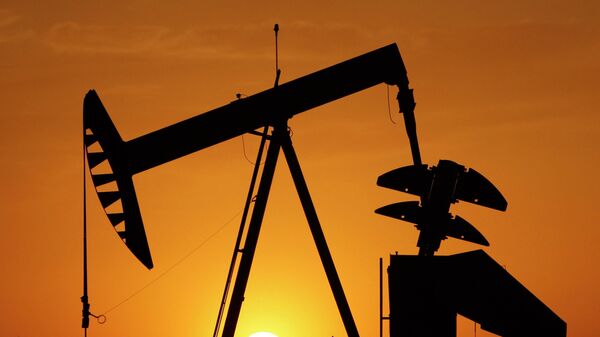 A pump jack is silhouetted against the setting sun in Oklahoma City on March 22, 2012.  - Sputnik International