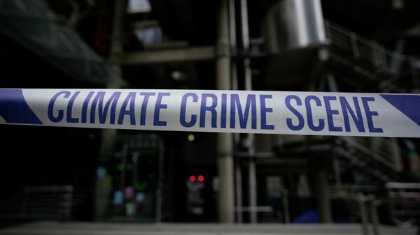 Climate Crime Scene tape put up by Extinction Rebellion climate change protesters is displayed during an action which closed down the Lloyds of London insurance company building for the day, in the City of London financial district of London, Tuesday, April 12, 2022. - Sputnik International