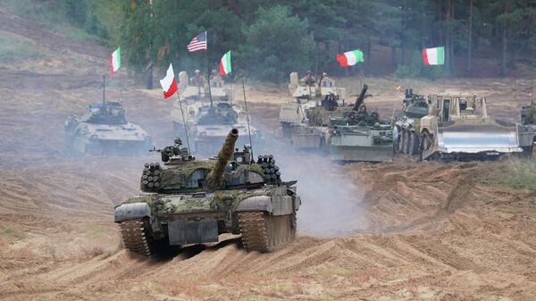Military vehicles and tanks of Poland, Italy, Canada and United States roll during the NATO military exercises ''Namejs 2021'' at a training ground in Kadaga, Latvia, on Monday, Sept. 13, 2021. - Sputnik International