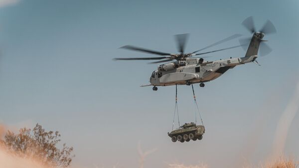 A Sikorsky CH-53K King Stallion with Marine Operational Test and Evaluation Squadron 1 conducts a lift of an external cargo load during a cargo loading and transporting exercise at Marine Corps Air Ground Combat Center, Twentynine Palms, California, Aug. 24, 2021. - Sputnik International