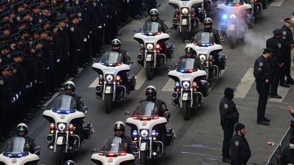 Motorcycle police from various jurisdictions lead an escort for the hearse carrying NYPD Officer Wilbert Mora's casket after Mora's funeral service at St. Patrick's Cathedral, Wednesday, Feb. 2, 2022, in New York. - Sputnik International