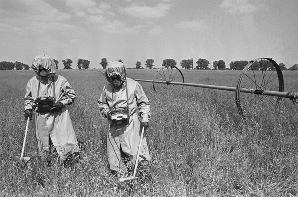 The contamination of soil, water, and vegetation had a long-lasting effect on the ecosystem and the agriculture in the affected areas.Above: Dosimetrists in special suits monitor radiation in fields in the vicinity of the Chernobyl NPP accident. - Sputnik International