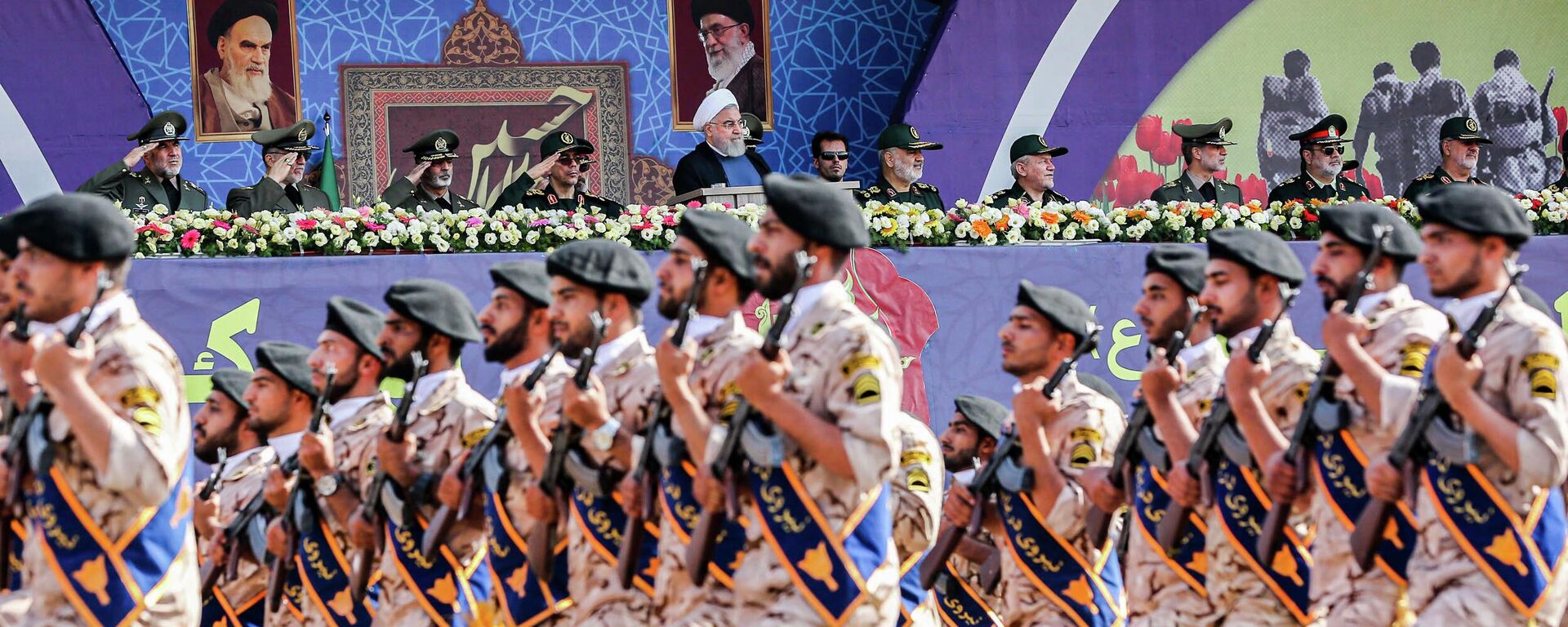 A handout picture provided by the Iranian presidency on September 22, 2019 shows President Hassan Rouhani (C) and other top military commanders watching members the Islamic Revolutionary Guard Corps (IRGC) marching past during the annual Sacred Defence Week military parade marking the anniversary of the outbreak of the devastating 1980-1988 war with Saddam Hussein's Iraq, in the capital Tehran. - Rouhani said on September 22 that the presence of foreign forces creates insecurity in the Gulf, after the US ordered the deployment of more troops to the region. Foreign forces can cause problems and insecurity for our people and for our region, Rouhani said in a televised speech at the annual military parade, adding that Iran would present to the UN a regional cooperation plan for peace. (Photo by Iranian Presidency / AFP) - Sputnik International, 1920, 24.05.2022