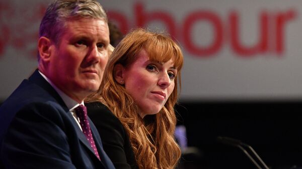 Britain's main opposition Labour Party leader Keir Starmer (L) and Britain's main opposition Labour Party deputy leader Angela Rayner sit in the conference hall for the the debate on the leadership election rules changes, on the second day of the annual Labour Party conference at The Brighton Centre in Brighton on the south coast of England, on September 26, 2021 - Sputnik International