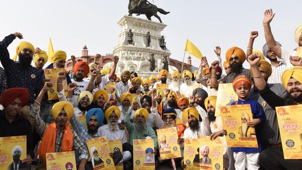 Members of the Sikh organization Akal Purakh Ki Fauj shout slogans and hold placards during 'Turban Day', which aims to inspire pride and maintain the distinct identity of Sikhs in the world, celebrations in Amritsar on April 13, 2022.  - Sputnik International