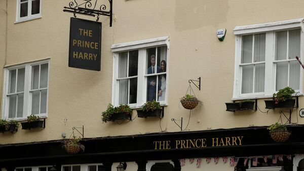 A large photograph of Prince Harry and his wife Meghan is displayed in an upstairs window of the Prince Harry pub, which is temporarily closed due to coronavirus restrictions, in Windsor, England, Tuesday, March 16, 2021 - Sputnik International