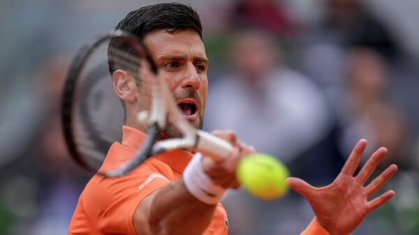 Serbia's Novak Djokovic returns the ball against Gael Monfils, of France, during their match at the Mutua Madrid Open tennis tournament in Madrid, Spain, Tuesday, May 3, 2022 - Sputnik International