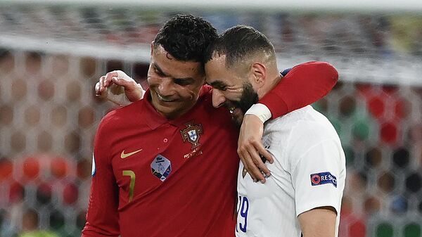 Portugal's forward Cristiano Ronaldo and France's forward Karim Benzema walk together off the pitch in half-time of the UEFA EURO 2020 Group F football match between Portugal and France at Puskas Arena in Budapest on June 23, 2021 - Sputnik International