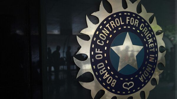 Journalists are reflected on a logo of the Board of Control for Cricket in India (BCCI) - Sputnik International