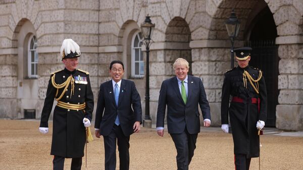 Britain's Prime Minister Boris Johnson, centre right, reacts as he walks with Japan's Prime Minister Fumio Kishida, centre left, to review an Honour Guard, during a welcoming ceremony in Westminster, London - Sputnik International