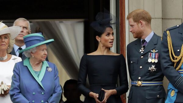 In this Tuesday, July 10, 2018 file photo Britain's Queen Elizabeth II, Meghan the Duchess of Sussex and Prince Harry stand on a balcony to watch a flypast of Royal Air Force aircraft pass over Buckingham Palace in London. - Sputnik International