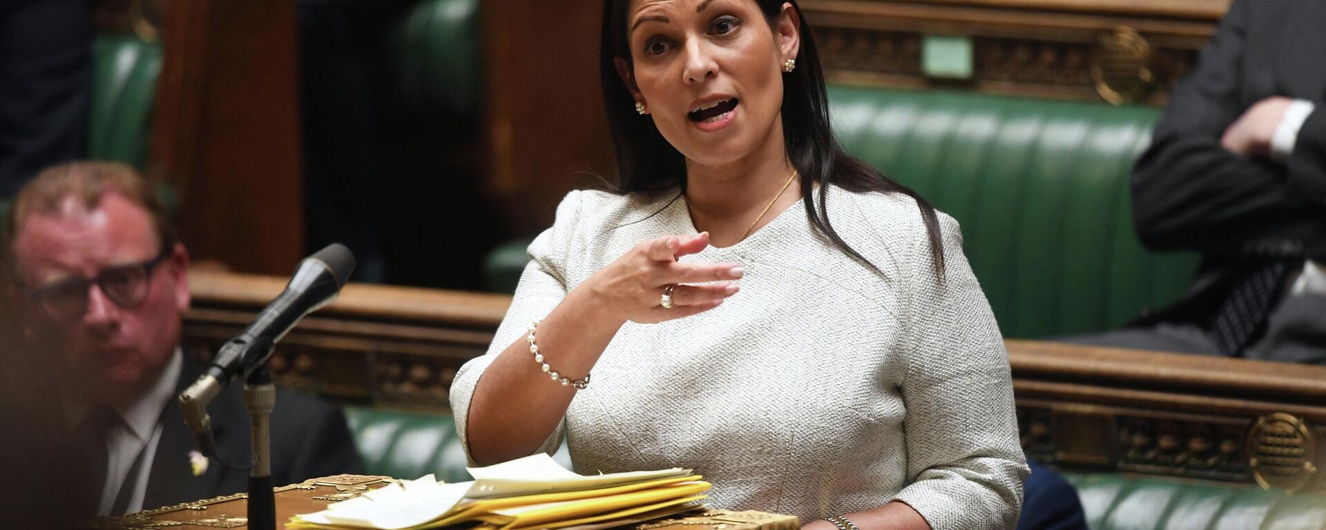 A handout photograph released by the UK Parliament shows Britain's Home Secretary Priti Patel gesturing as she gives a statement concerning the deal plan to send migrants and asylum seekers who cross the Channel to Rwanda, at the House of Commons, in London, on April 19, 2022 - Sputnik International, 1920, 07.05.2022
