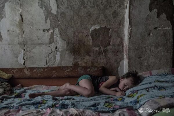 Ruslan Pykhtin, a seven-year-old boy, in a house near the contact line on the outskirts of Donetsk. A photo from the “Grey Zone” series that won the Grand Prix in the Intarget Photolux Award 2019 photo contest. - Sputnik International
