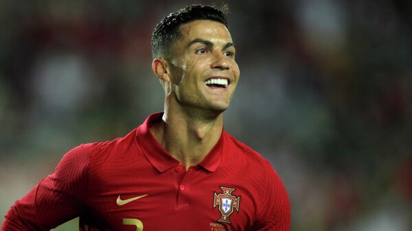 Portugal's Cristiano Ronaldo smiles after scoring the opening goal during the international friendly soccer match between Portugal and Qatar at the Algarve stadium outside Faro, Portugal, Saturday, Oct. 9, 2021 - Sputnik International