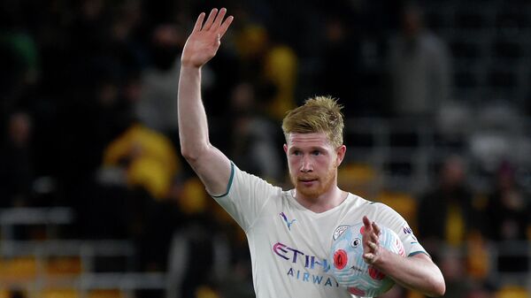 Manchester City's Kevin De Bruyne leaves the field with the match ball at the end of the English Premier League soccer match between Wolverhampton Wanderers and Manchester City at Molineux stadium in Wolverhampton, England, Wednesday, May 11, 2022 - Sputnik International