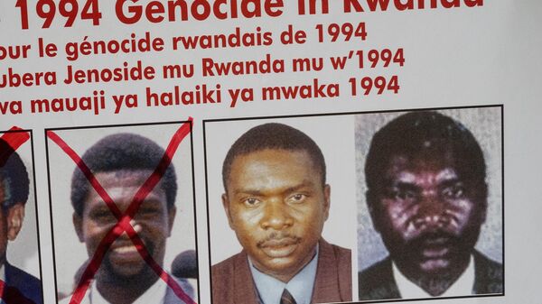 A picture taken on May 19, 2020, shows the faces of Protais Mpiranya, one of the key suspects in the 1994 Rwandan genocide, on a wanted poster on the wall at the Genocide Fugitive Tracking Unit office in Kigali, Rwanda. - Sputnik International