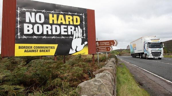 A vechile passes an anti-Brexit pro-Irish unity billboard seen from the Dublin road in Newry, Northern Ireland, on October 1, 2019 on the border between Newry in Northern Ireland and Dundalk in the Irish Republic - Sputnik International