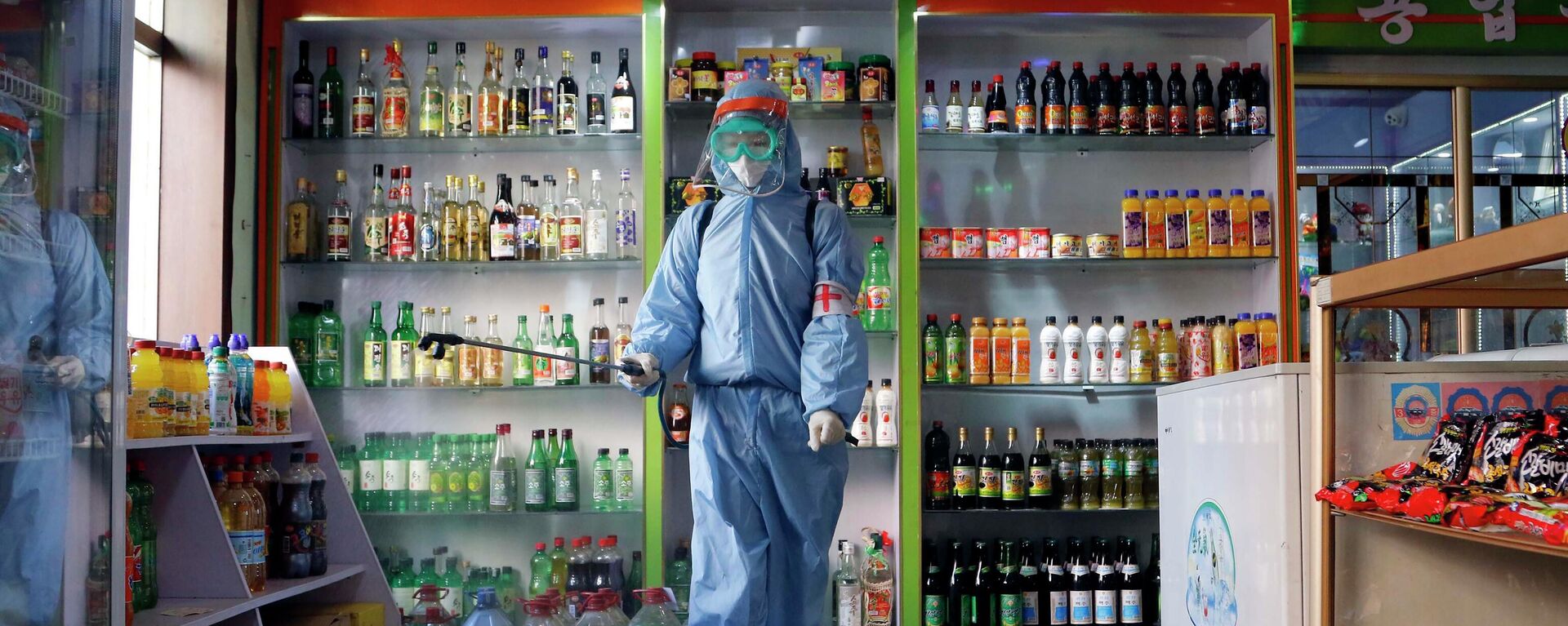 FILE - An employee of the Kyonghung Foodstuff General Store disinfects the showroom in Pyongyang, North Korea, Wednesday, Nov. 10, 2021. Before acknowledging domestic COVID-19 cases, Thursday, May 12, 2022, North Korea spent 2 1/2 years rejecting outside offers of vaccines and steadfastly claiming that its superior socialist system was protecting its 26 million people from “a malicious virus” that had killed millions around the world. - Sputnik International, 1920, 11.08.2022