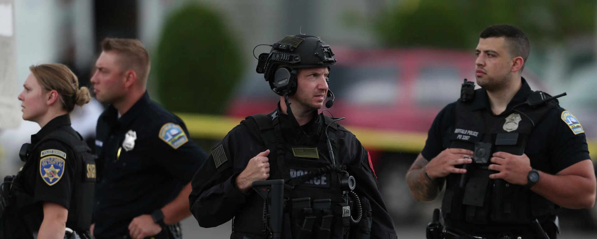 Police walk along the perimeter of the scene after a shooting at a supermarket on Saturday, May 14, 2022, in Buffalo, N.Y.  Officials said the gunman entered the supermarket with a rifle and opened fire. Investigators believe the man may have been livestreaming the shooting and were looking into whether he had posted a manifesto online.  - Sputnik International, 1920, 23.05.2022