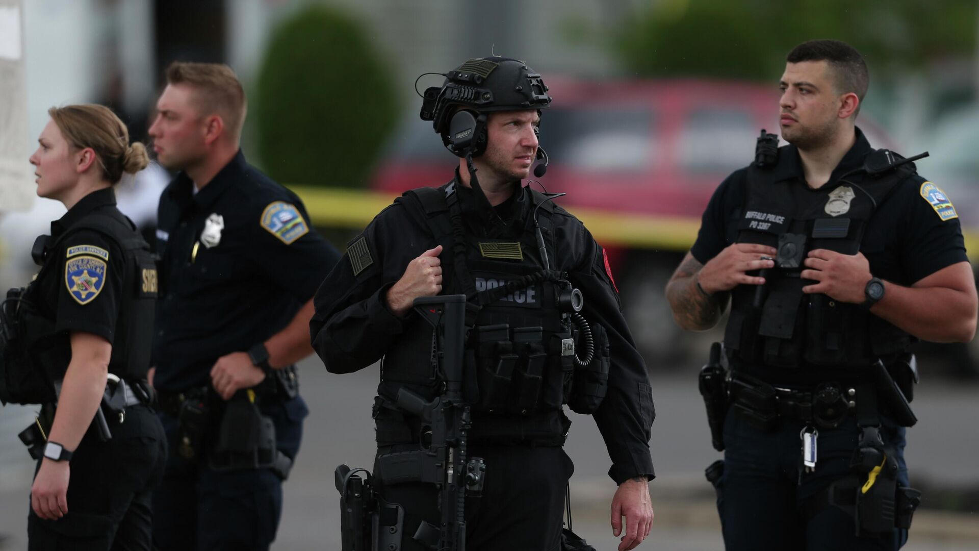 Police walk along the perimeter of the scene after a shooting at a supermarket on Saturday, May 14, 2022, in Buffalo, N.Y.  Officials said the gunman entered the supermarket with a rifle and opened fire. Investigators believe the man may have been livestreaming the shooting and were looking into whether he had posted a manifesto online.  - Sputnik International, 1920, 15.05.2022