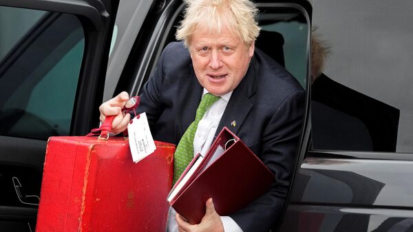 Britain's Prime Minister Boris Johnson caries his ministerial red box as he exits a car to board a flight from London Stansted airport, on May 11, 2022 - Sputnik International
