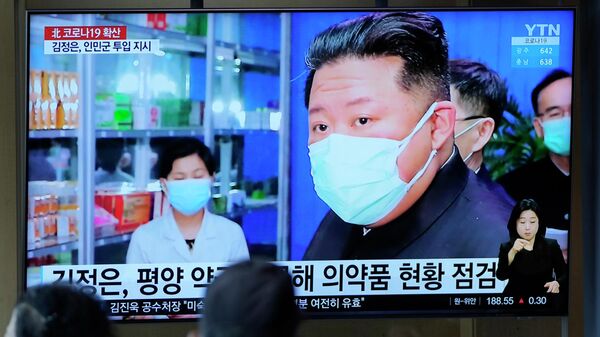 FILE - People watch a TV screen showing a news program reporting with an image of North Korean leader Kim Jong Un, at a train station in Seoul, South Korea on May 16, 2022 - Sputnik International