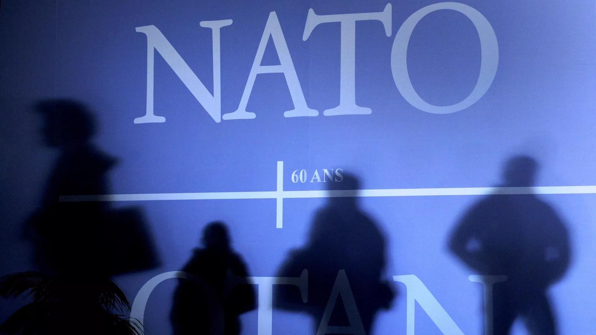 This April 2, 2009 file photo shows shadows cast on a wall decorated with the NATO logo and flags of NATO countries in Strasbourg, eastern France, before the start of the NATO summit which marked the organisation's 60th anniversary.  - Sputnik International, 1920, 06.01.2024
