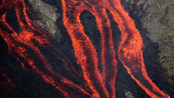 Lava flows out of the Piton de la Fournaise volcano as it erupts on July 31, 2015 on the French island of La Reunion in the Indian Ocean. - Sputnik International