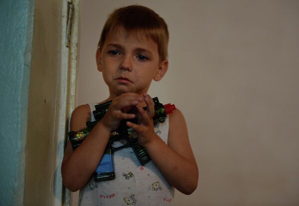 This is a refugee from Slavyansk town in a healthcare centre in Zarya mine in Snezhnyi, Donetsk. The boy holds a toy assault rifle in his hands. In the summer of 2014, Ukrainian soldiers armed with real weapons entered his hometown and unleashed a war against the local population on Kiev’s orders. - Sputnik International