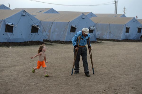 The elderly and children are the most unprotected and helpless sector of the population during a war. Some of them, who were strong enough, were evacuated to Russia. The photo shows an old man and a girl at a Donbass refugee camp in the Rostov region in 2014. - Sputnik International
