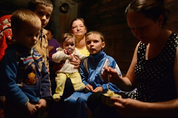 For eight years, locals got used to waiting out the shelling in basements and listening to the sounds of the shells’ arrival. Donetsk children know how to distinguish shells by their &quot;whistle&quot;, and many of them were born and have already grown up amidst this war. The photo shows women with children hiding from shelling in the basement of a house in Kramatorsk in 2014. - Sputnik International