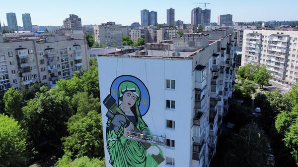 A worker paints a Saint Javelin, a Virgin Mary holding an American-made anti-tank missile, in Kyiv, Ukraine, Tuesday, May 24, 2022 - Sputnik International