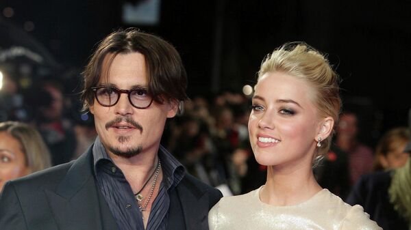 In this Nov. 3, 2011 file photo, U.S. actors Johnny Depp, left, and Amber Heard arrive for the European premiere of their film, The Rum Diary, in London.Heard is asking a judge to dismiss a $50 million defamation lawsuit her ex-husband Johnny Depp filed over a Washington Post op-ed she wrote about domestic violence. In the motion filed Thursday in Fairfax, Virginia, Heard’s lawyers reiterate allegations that Depp abused her and include exhibits such as photos of her with bruised face and scarred arms.  - Sputnik International