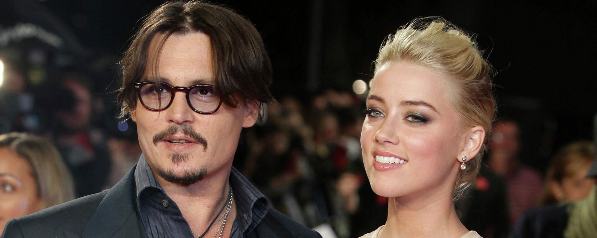 In this Nov. 3, 2011 file photo, U.S. actors Johnny Depp, left, and Amber Heard arrive for the European premiere of their film, The Rum Diary, in London.Heard is asking a judge to dismiss a $50 million defamation lawsuit her ex-husband Johnny Depp filed over a Washington Post op-ed she wrote about domestic violence. In the motion filed Thursday in Fairfax, Virginia, Heard’s lawyers reiterate allegations that Depp abused her and include exhibits such as photos of her with bruised face and scarred arms.  - Sputnik International, 1920, 01.06.2022