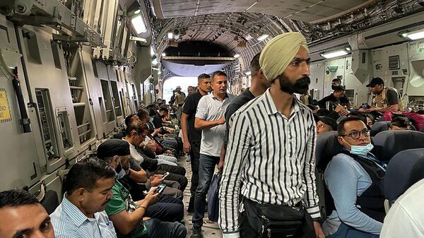 Indian nationals sit aboard an Indian military aircraft at the airport in Kabul on August 17, 2021 to be evacuated after the Taliban stunning takeover of Afghanistan - Sputnik International