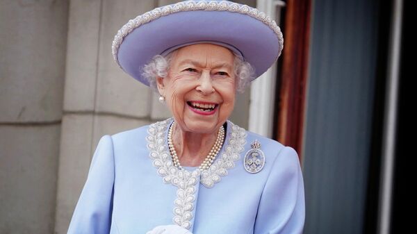 Queen Elizabeth II watches with a smile from the balcony of Buckingham Palace after the Trooping the Color ceremony in London, Thursday, June 2, 2022, on the first of four days of celebrations to mark the Platinum Jubilee. The events over a long holiday weekend in the U.K. are meant to celebrate the monarch's 70 years of service. - Sputnik International