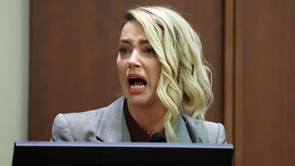 (FILES) In this file photo taken on May 26, 2022, US actor Amber Heard testifies during the Depp vs Heard defamation trial at the Fairfax County Circuit Court in Fairfax, Virginia. - Sputnik International