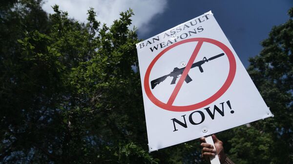 HOUSTON, TX - MAY 27: A gun control advocate holds a sign during a protest across from the National Rifle Association Annual Meeting at the George R. Brown Convention Center, on May 27, 2022 in Houston, Texas.  - Sputnik International