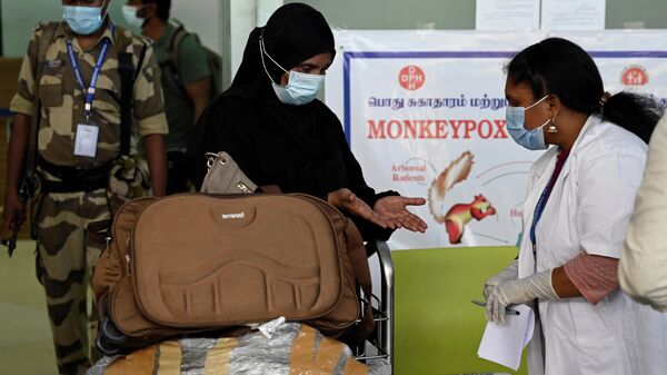 Health workers screen passengers arriving from abroad for Monkeypox symptoms at Anna International Airport terminal in Chennai on June 03, 2022. - Sputnik International