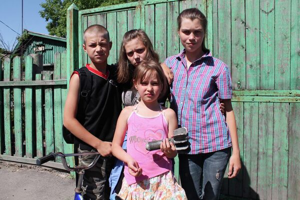 Children&#x27;s curiosity often turned into tragedy. Dozens of young residents of Donbass have suffered due to exploding landmines. After picking up shells, they died or lost their arms and legs. In this photo, taken in 2015, children from the city of Donetsk are seen showing a fragment of a shell that hit their home. - Sputnik International