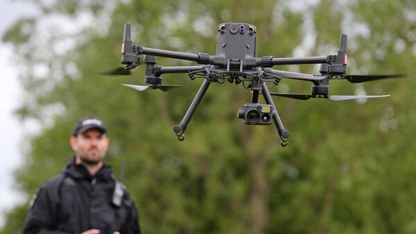 Acting Police Sergeant Chris Linzey pilots a DJI Matrice M300 drone (UAV) during a demonstration for media ahead of the upcoming in-person G7 Summit to be held in Cornwall, at the Police headquarters in Exeter, southwest England on May 25, 2021. - Sputnik International