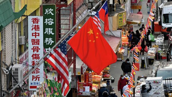 A Chinese flag hangs between American flags in Chinatown on February 17, 2021 in New York City - Sputnik International