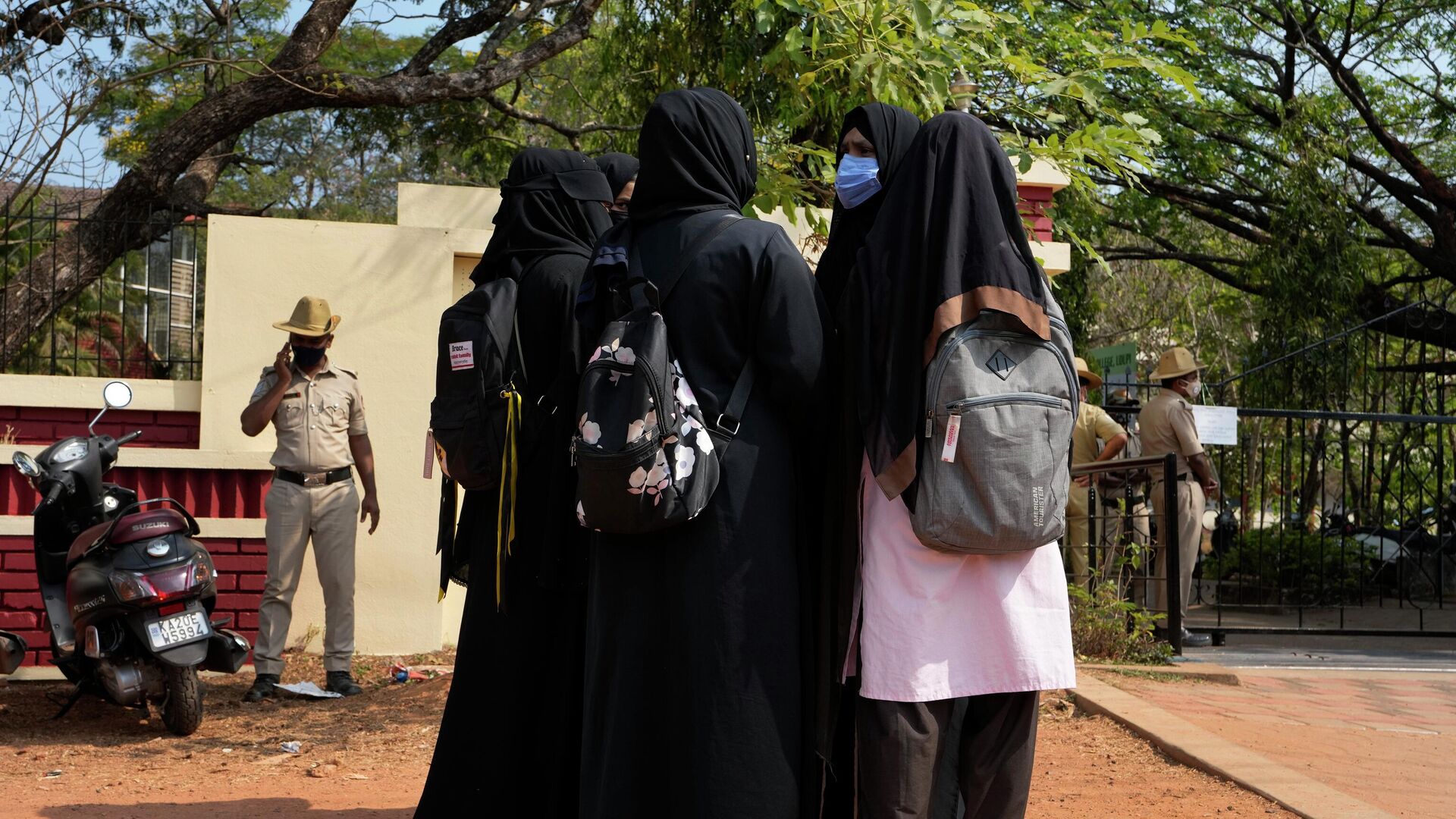 An Indian Muslim student wearing school uniform and hijab listens to fellow students wearing burqas after they were denied entry into the campus of Mahatma Gandhi Memorial college in Udupi, Karnataka state, India, Thursday, Feb. 24, 2022 - Sputnik International, 1920, 07.06.2022