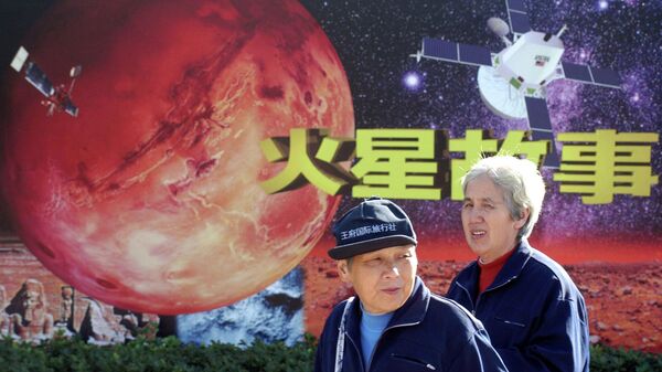 People walk past a propaganda of an event called Mars Story at a planetarium Tuesday Oct. 14, 2003 in Beijing, China - Sputnik International
